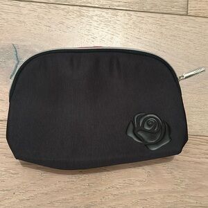 Lancôme black cosmetics bag with Rose logo on the front